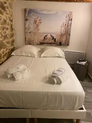 a bedroom with a bed with two towels on it at Studio Suquet Saint Antoine in Cannes