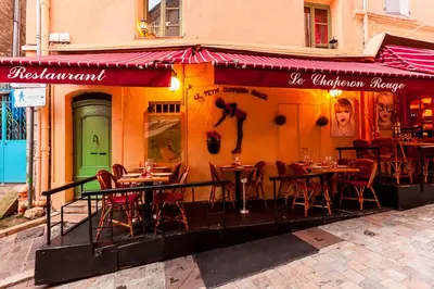 a restaurant with tables and chairs outside of a building at Studio Suquet Saint Antoine in Cannes
