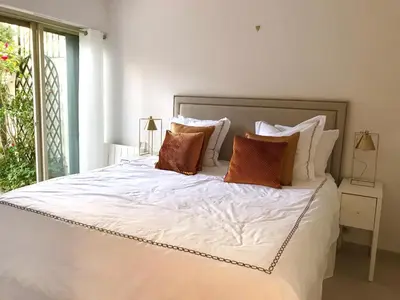 a bedroom with a large white bed with pillows at 19 Rue du Parc Alexandre III in Cannes