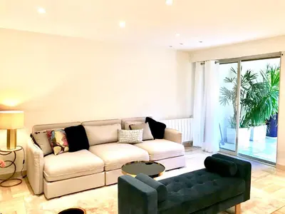 a living room with a couch and a table at 19 Rue du Parc Alexandre III in Cannes