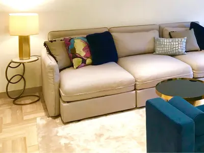a living room with a couch and a table at 19 Rue du Parc Alexandre III in Cannes