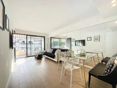 a living room with a couch and a table at 3P BETWEEN CROISETTE BEACHES AND ANTIBES STREET in Cannes