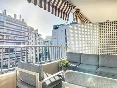 a balcony with a couch and chairs on a building at 3P BETWEEN CROISETTE BEACHES AND ANTIBES STREET in Cannes