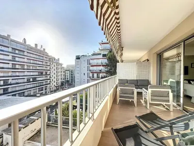 a balcony with chairs and a view of a city at 3P BETWEEN CROISETTE BEACHES AND ANTIBES STREET in Cannes