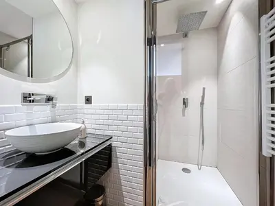 a white bathroom with a sink and a shower at 3P BETWEEN CROISETTE BEACHES AND ANTIBES STREET in Cannes