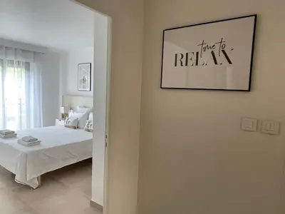 a bedroom with a bed and a picture on the wall at Domaine D'Ahmosis, modern 2 bedrooms refurbished apartment, f3 moderne fraichement rénové in Le Cannet