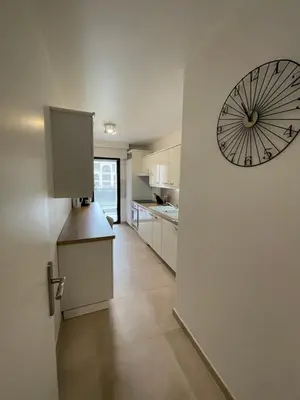 a kitchen with a large clock on the wall at Domaine D'Ahmosis, modern 2 bedrooms refurbished apartment, f3 moderne fraichement rénové in Le Cannet