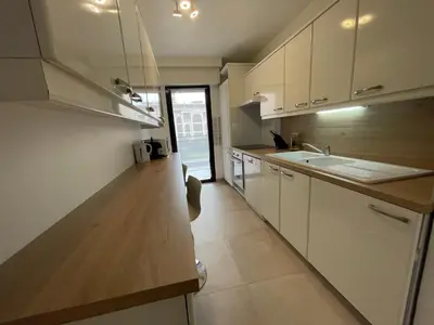 a kitchen with white cabinets and a sink at Domaine D'Ahmosis, modern 2 bedrooms refurbished apartment, f3 moderne fraichement rénové in Le Cannet