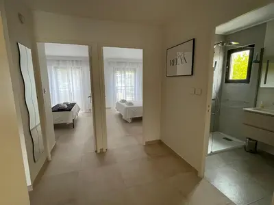 a hallway with a bathroom and a room with a tub at Domaine D'Ahmosis, modern 2 bedrooms refurbished apartment, f3 moderne fraichement rénové in Le Cannet