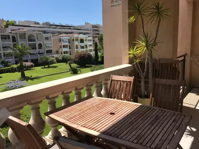 a wooden table and two chairs on a balcony at Domaine D'Ahmosis, modern 2 bedrooms refurbished apartment, f3 moderne fraichement rénové in Le Cannet