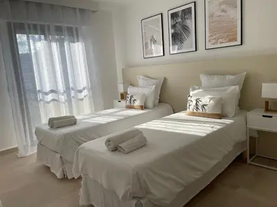 two beds in a room with two windows at Domaine D'Ahmosis, modern 2 bedrooms refurbished apartment, f3 moderne fraichement rénové in Le Cannet