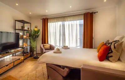 a bedroom with a large bed and a large window at Très jolie studio au pied du Suquet Cannes in Cannes