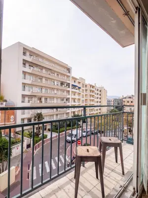 a balcony with two chairs and a view of a city at Très jolie studio au pied du Suquet Cannes in Cannes