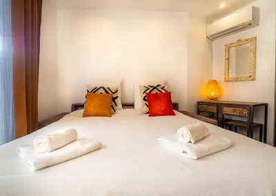 a bedroom with a white bed with towels on it at Très jolie studio au pied du Suquet Cannes in Cannes