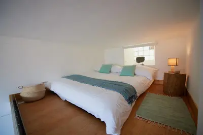 a bedroom with a large white bed with a window at 6 Rue Coste Corail in Cannes