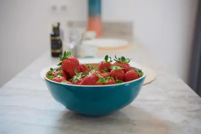 a blue bowl filled with strawberries on a counter at 6 Rue Coste Corail in Cannes