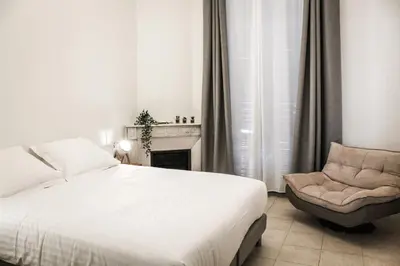 a bedroom with a bed and a chair at Best quality price ! - Central - 350m Palais and Croisette in Cannes