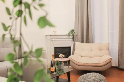 a living room with a chair and a fireplace at Best quality price ! - Central - 350m Palais and Croisette in Cannes