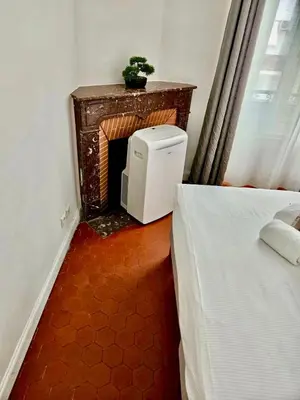 a room with a fireplace and a bed and a table at Best quality price ! - Central - 350m Palais and Croisette in Cannes