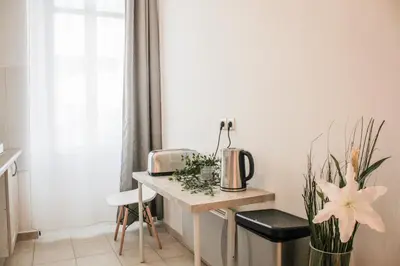 a kitchen with a table and a vase with flowers at Best quality price ! - Central - 350m Palais and Croisette in Cannes