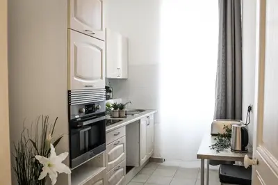a kitchen with white cabinets and a stove top oven at Best quality price ! - Central - 350m Palais and Croisette in Cannes