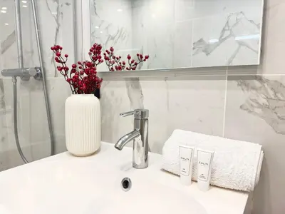 a white bathroom with a sink and a shower at Luxueux 3 pièces de 80m2 -2 chambres, 2 salles de bain- A 1mn de la Croisette et des plages in Cannes