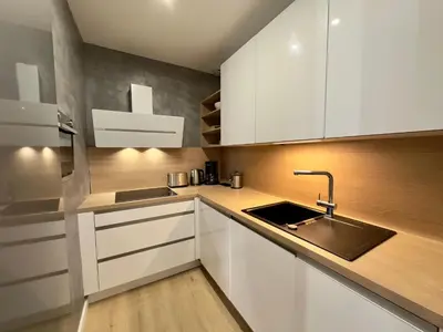 a kitchen with white cabinets and a sink at Luxueux 3 pièces de 80m2 -2 chambres, 2 salles de bain- A 1mn de la Croisette et des plages in Cannes