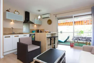 a kitchen with a table and chairs in a room at Cannes Vacances chez Steph in Cannes
