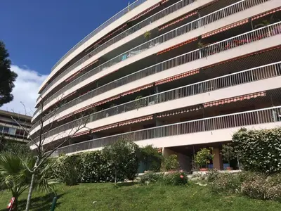 a large building with plants in front of it at Cannes Vacances chez Steph in Cannes