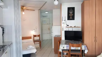 a kitchen and a living room with a table in a room at Calm Flat in Cannes
