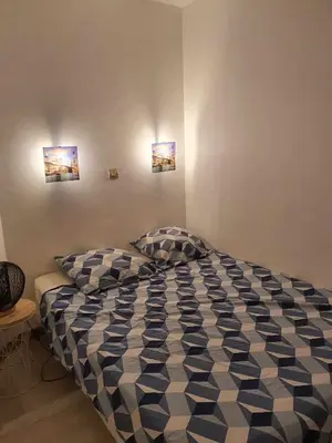 a bed in a bedroom with two pictures on the wall at Cyrnos in Cannes