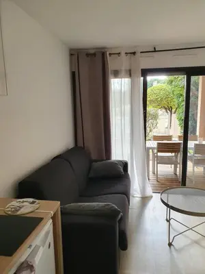 a living room with a couch and a table at Cyrnos in Cannes