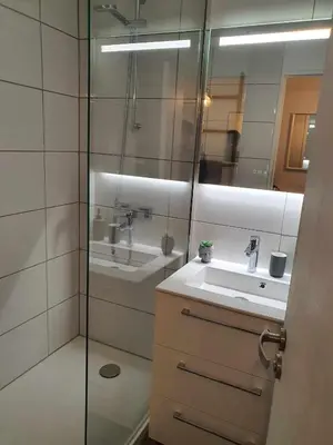 a bathroom with a shower and a sink and a mirror at Cyrnos in Cannes