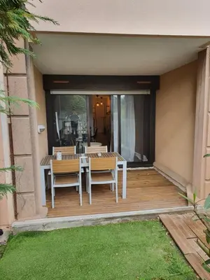 a patio with a table and chairs on a deck at Cyrnos in Cannes