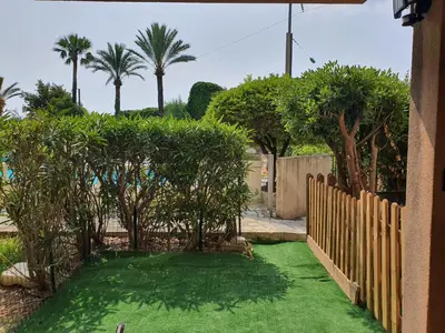 a yard with a fence and green grass at Cyrnos in Cannes