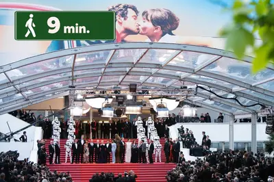 a group of people kissing on a red carpet at Grand Studio Cannes Centre in Cannes