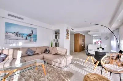 a living room with a couch and a table at REF 1147 - Cannes Center - Apartment for rent in Cannes
