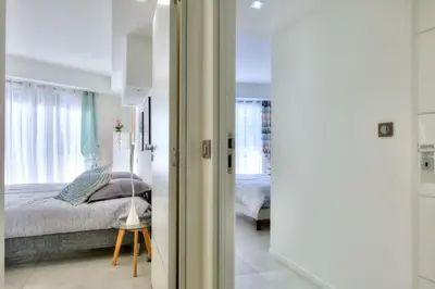 a bedroom with a bed and a window at REF 1147 - Cannes Center - Apartment for rent in Cannes