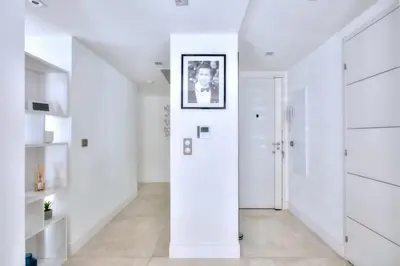 a hallway with white walls and white cabinets at REF 1147 - Cannes Center - Apartment for rent in Cannes