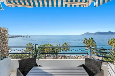a balcony with a view of the ocean at REF 1181 - Cannes Croisette - Sea view apartment for rent in Cannes