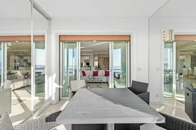 a dining room with a table and chairs at REF 1181 - Cannes Croisette - Sea view apartment for rent in Cannes