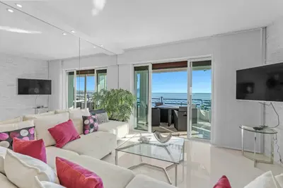 a living room with white furniture and a view of the ocean at REF 1181 - Cannes Croisette - Sea view apartment for rent in Cannes