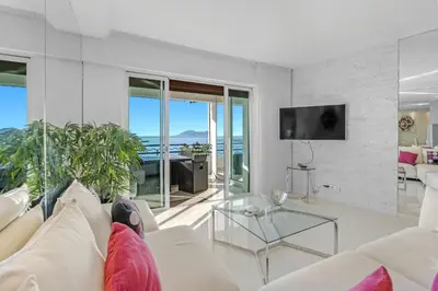a living room with a couch and a glass table at REF 1181 - Cannes Croisette - Sea view apartment for rent in Cannes