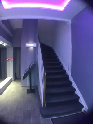 a staircase in a building with a neon light at Hotel Cannes Croisette in Cannes