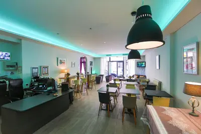 a restaurant with tables and chairs in a room at Hotel Cannes Croisette in Cannes