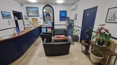 a salon with a counter and a waiting room at Hôtel du Nord in Cannes