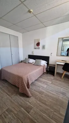 a bedroom with a bed and a table in a room at Hôtel du Nord in Cannes
