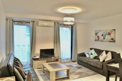 a living room with a couch and a tv at Centre Riviera 2P LHO5516 in Cannes