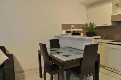 a kitchen with a table and chairs in it at Centre Riviera 2P LHO5516 in Cannes