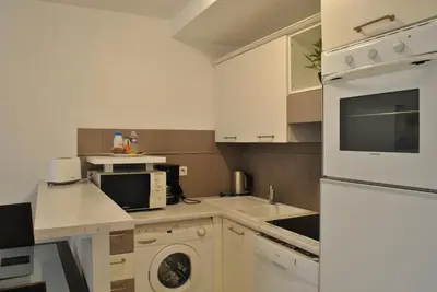 a kitchen with a white refrigerator and a dishwasher at Centre Riviera 2P LHO5516 in Cannes